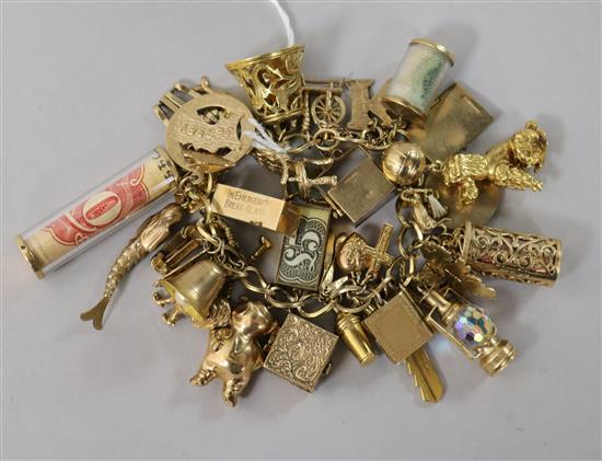 A 9ct gold charm bracelet hung with 41 charms (various) and with padlock clasp.